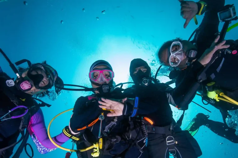 Divers preparing to enter the water from a liveaboard
