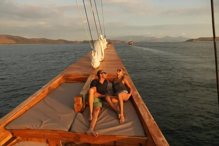 Guest relaxing on the sun deck of a phinisi